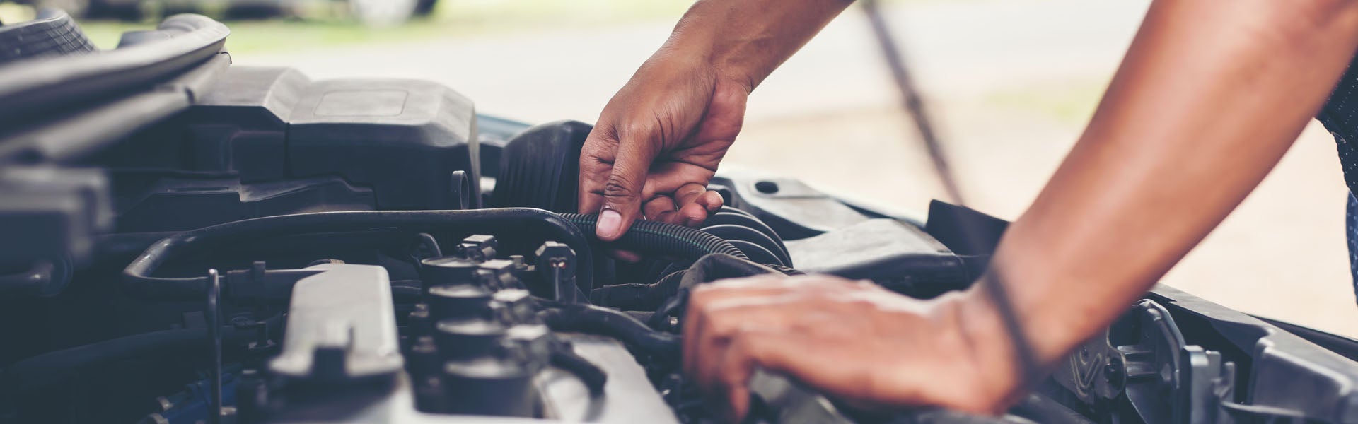 Man changing oil in car