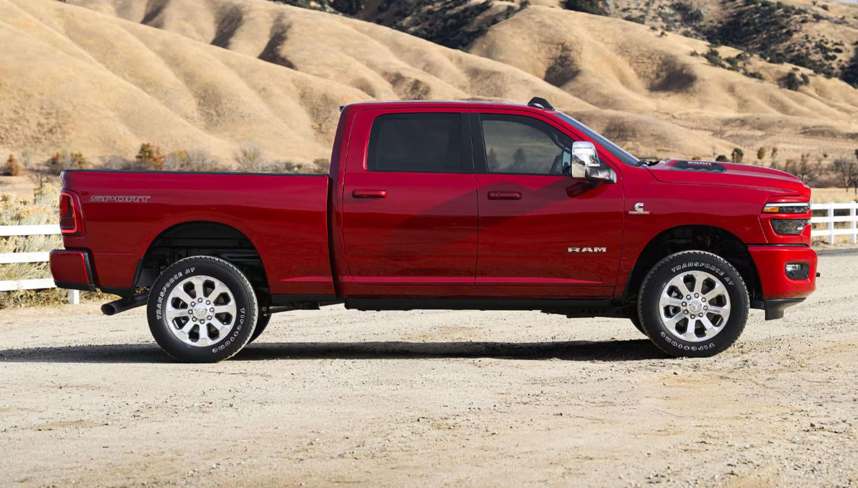A red RAM 2500 parked on a dirt road.
